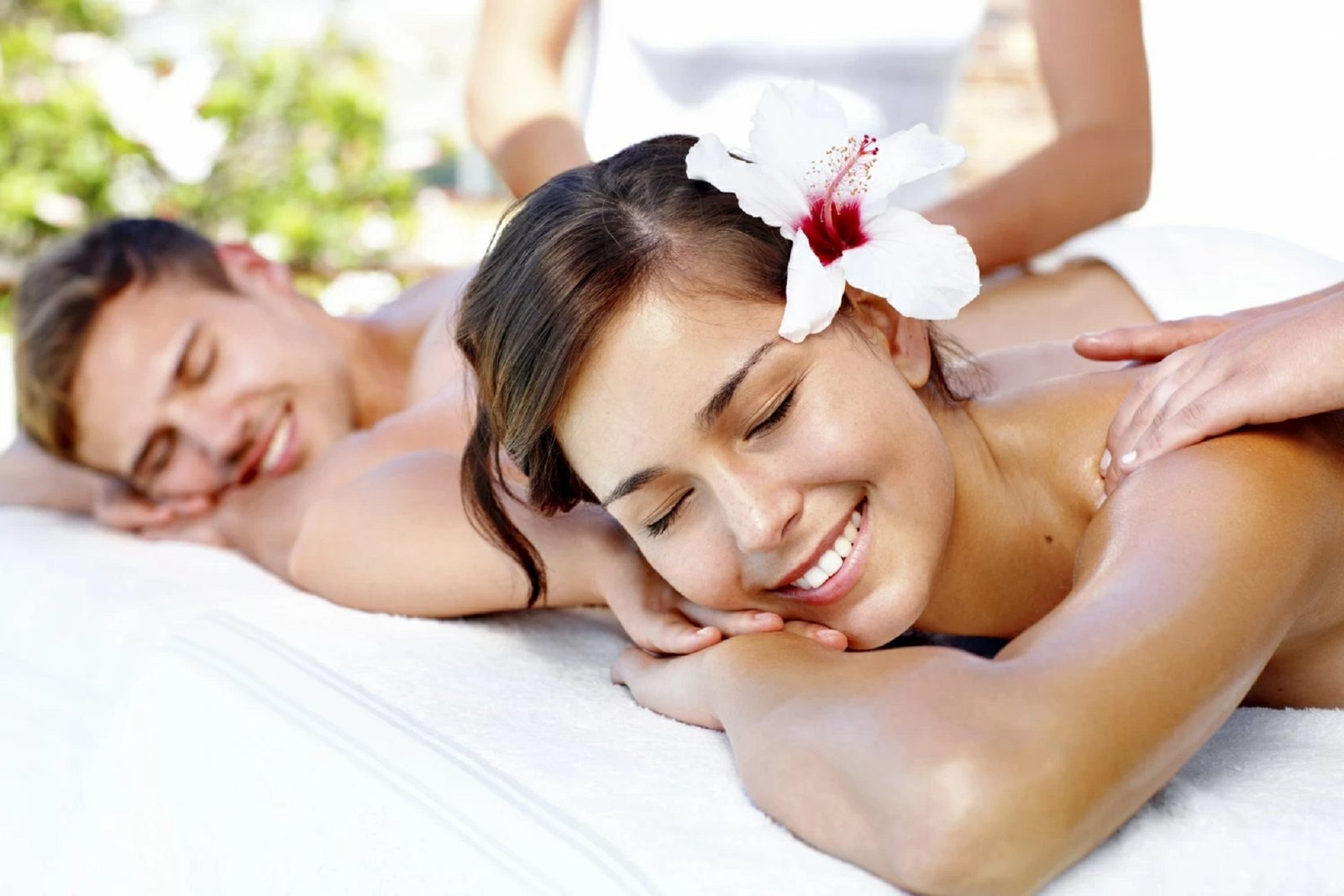 Relaxed man and woman enjoying a couple massage Chevy Chase with professional therapists in a serene spa setting.